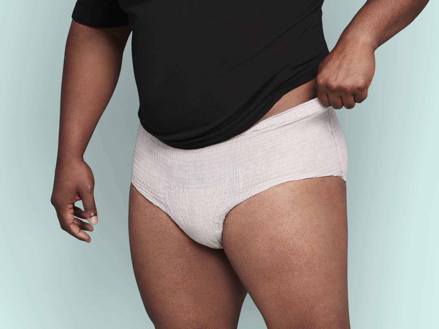 Model Wearing Depend® Incontinence Fresh Protection™ Plus+ Underwear for Men